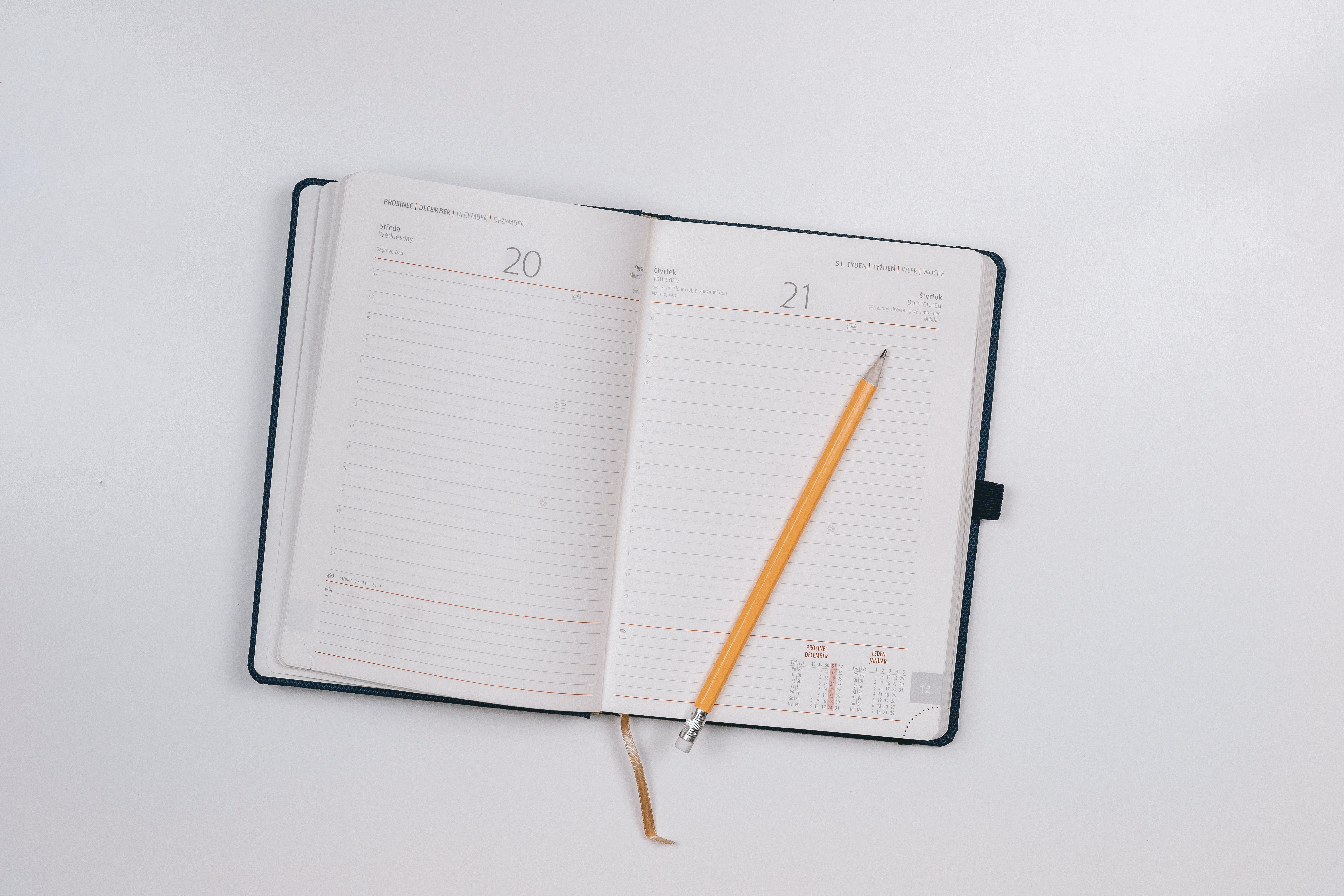 A standard day planner with a pencil
